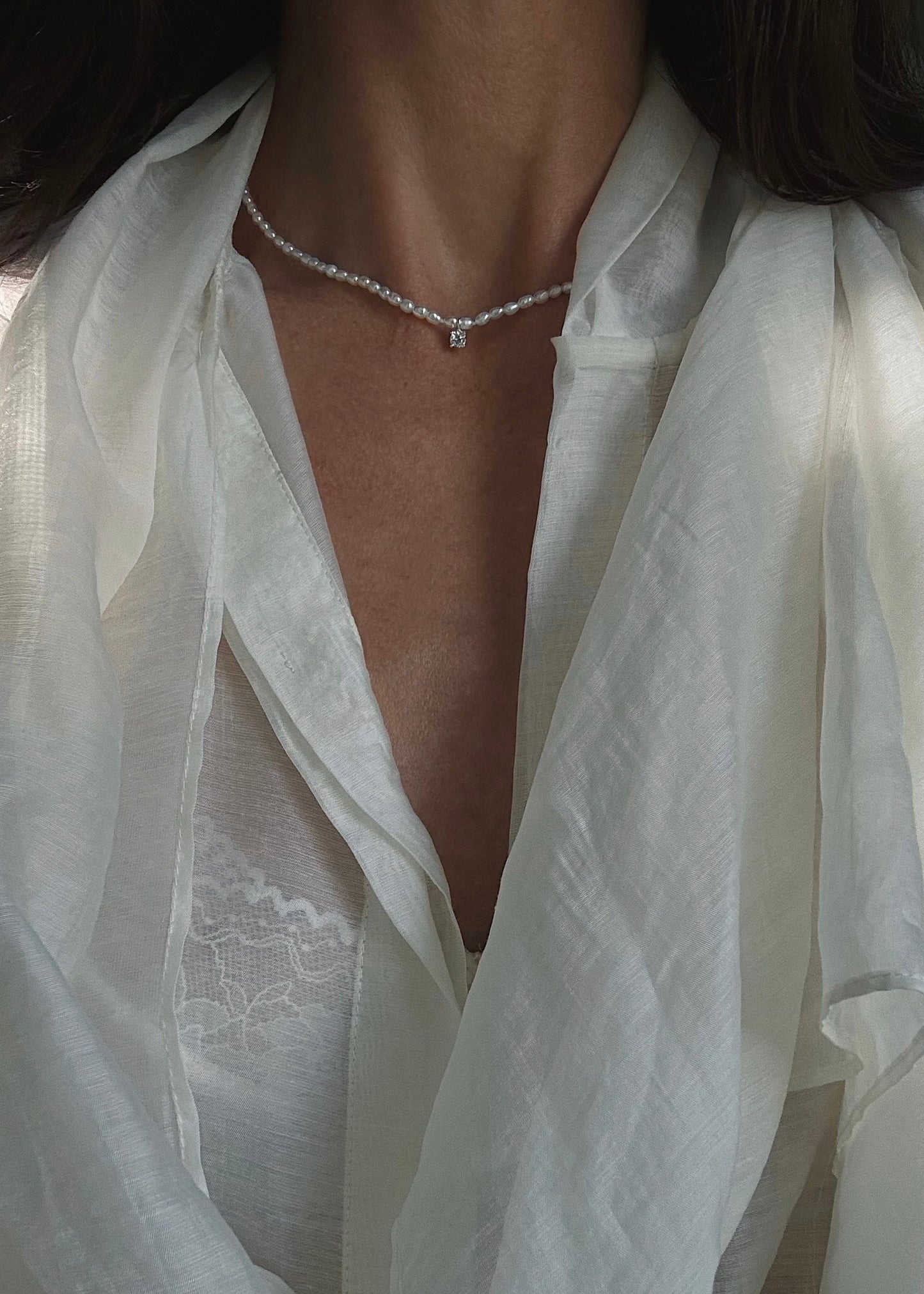 Close-up of a freshwater pearl necklace crafted in sterling silver 925 with semi-precious stone pendant.