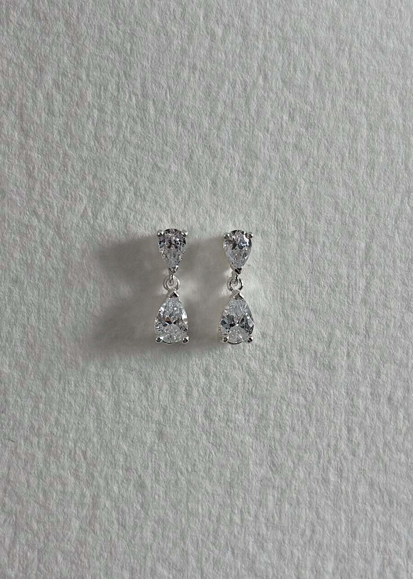 Silver earrings crafted in 925 sterling silver, adorned with semi-precious stones, featuring a timeless design that reflects soft elegance and subtle, luminous shine.