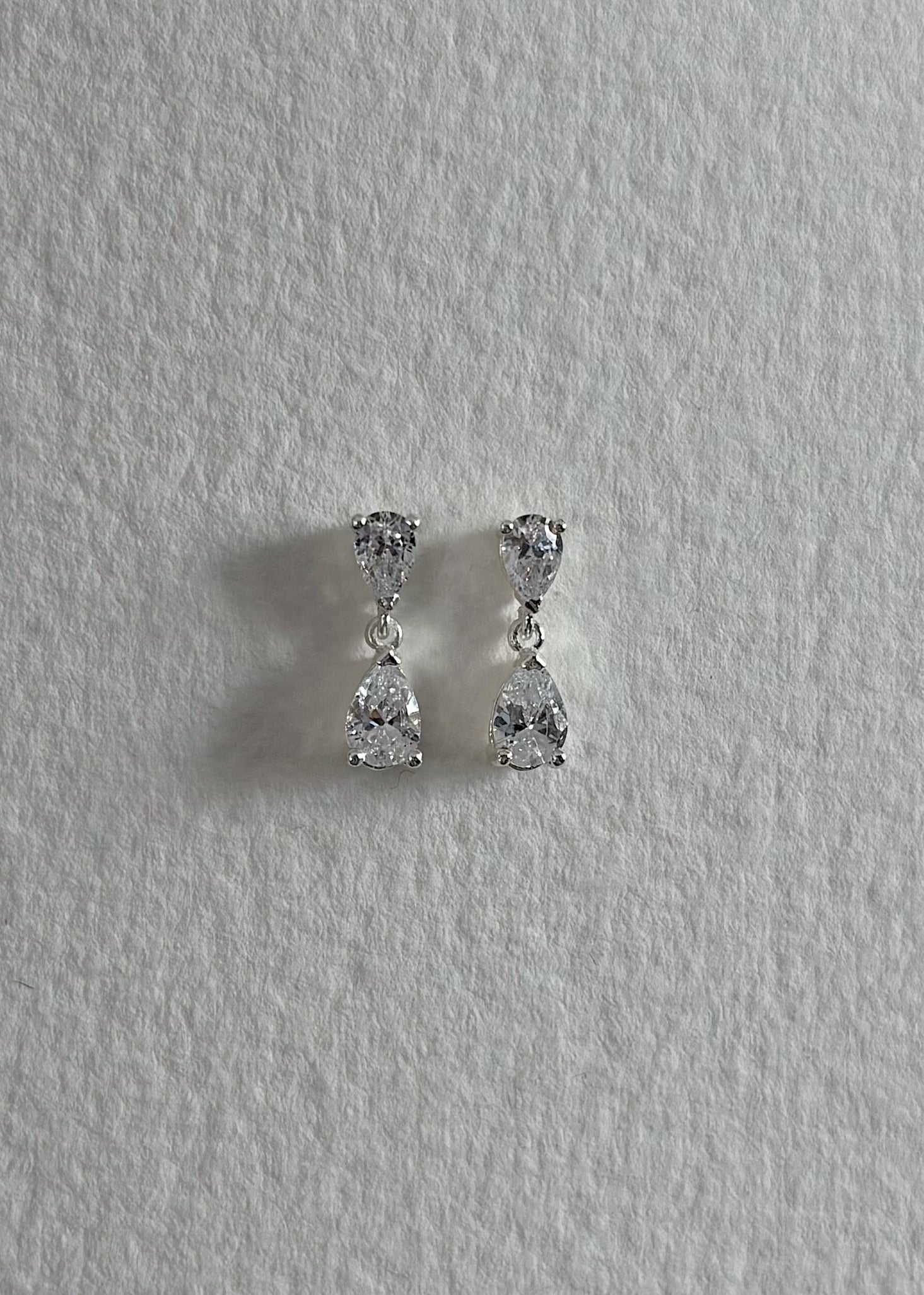 Silver earrings crafted in 925 sterling silver, adorned with semi-precious stones, featuring a timeless design that reflects soft elegance and subtle, luminous shine.