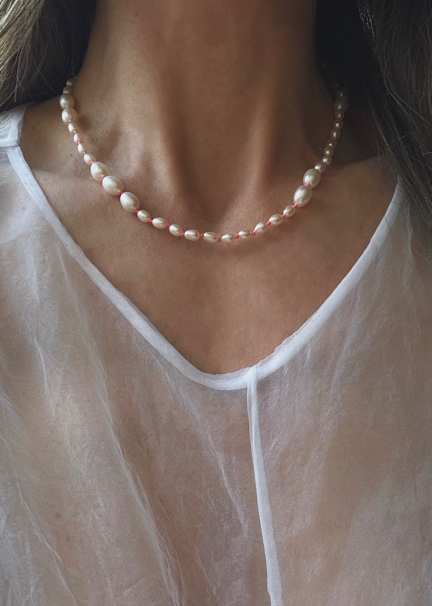 Elegant Malia freshwater pearl necklace handcrafted with genuine natural pearls in a timeless minimalist design for everyday wear.