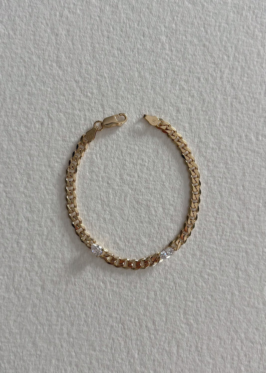 Gold bracelet adorned with semi-precious stones, featuring a timeless design that reflects modern elegance, refined craftsmanship, and subtle radiant shine.