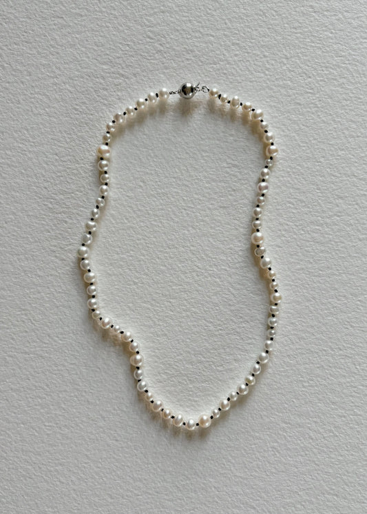 Freshwater pearl necklace featuring luminous, hand-selected pearls in a timeless design that embodies soft elegance, refined simplicity, and natural radiance.